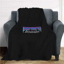 Load image into Gallery viewer, Philagonia Philadelphia Skyline Black Blanket | 62&quot;W x 78&quot;L on a couch
